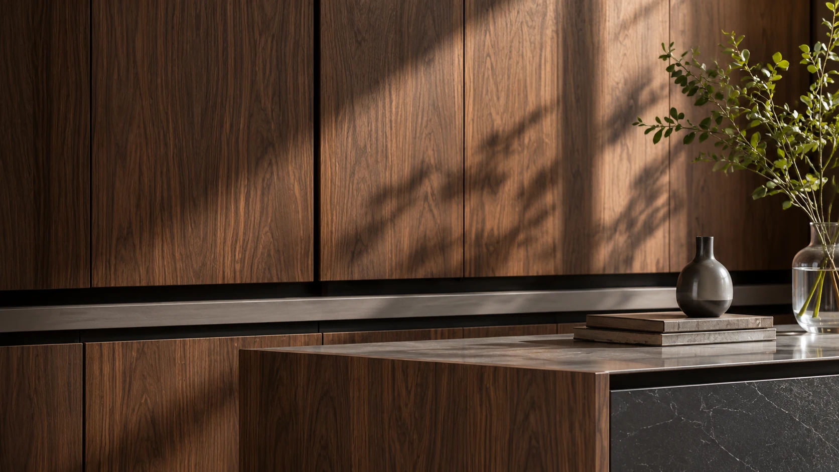 Walnut cabinetry with a dark stone countertop and a ceramic vase